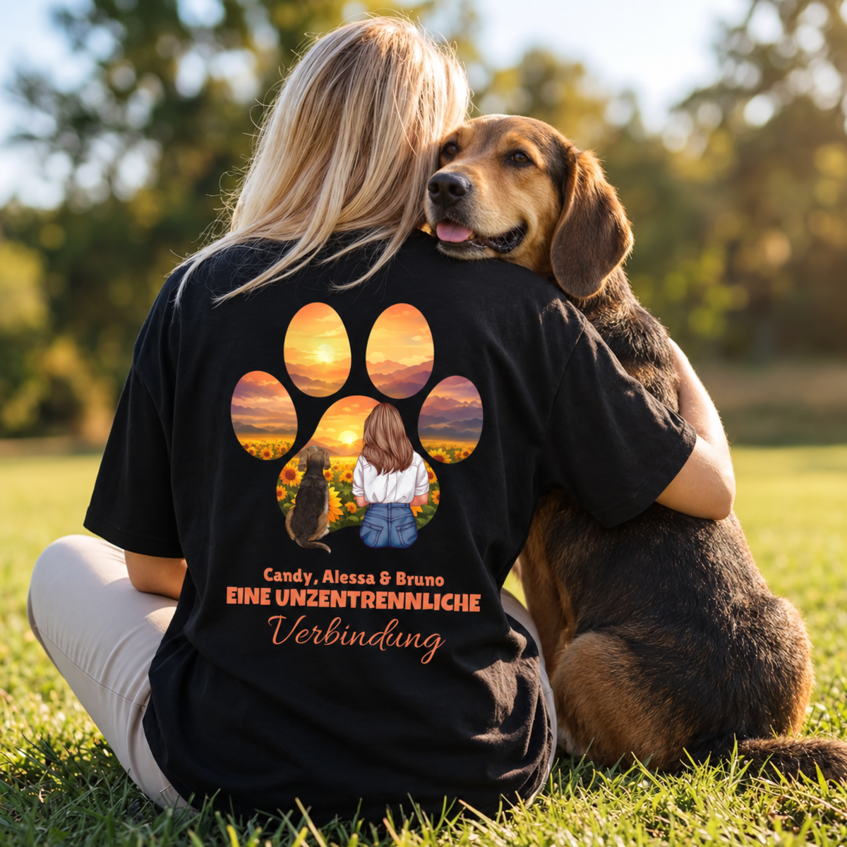 Camiseta negra con ilustración de una mujer y un perro rodeados de girasoles y el texto "Eine unzertrennliche Verbindung".