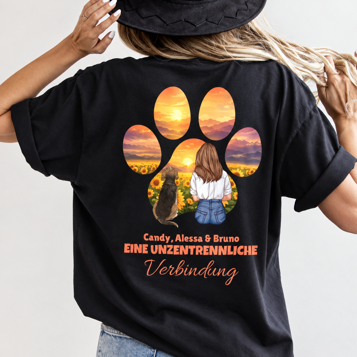 Camiseta negra con espalda impresa, con una mujer y un perro ante un atardecer y texto.
