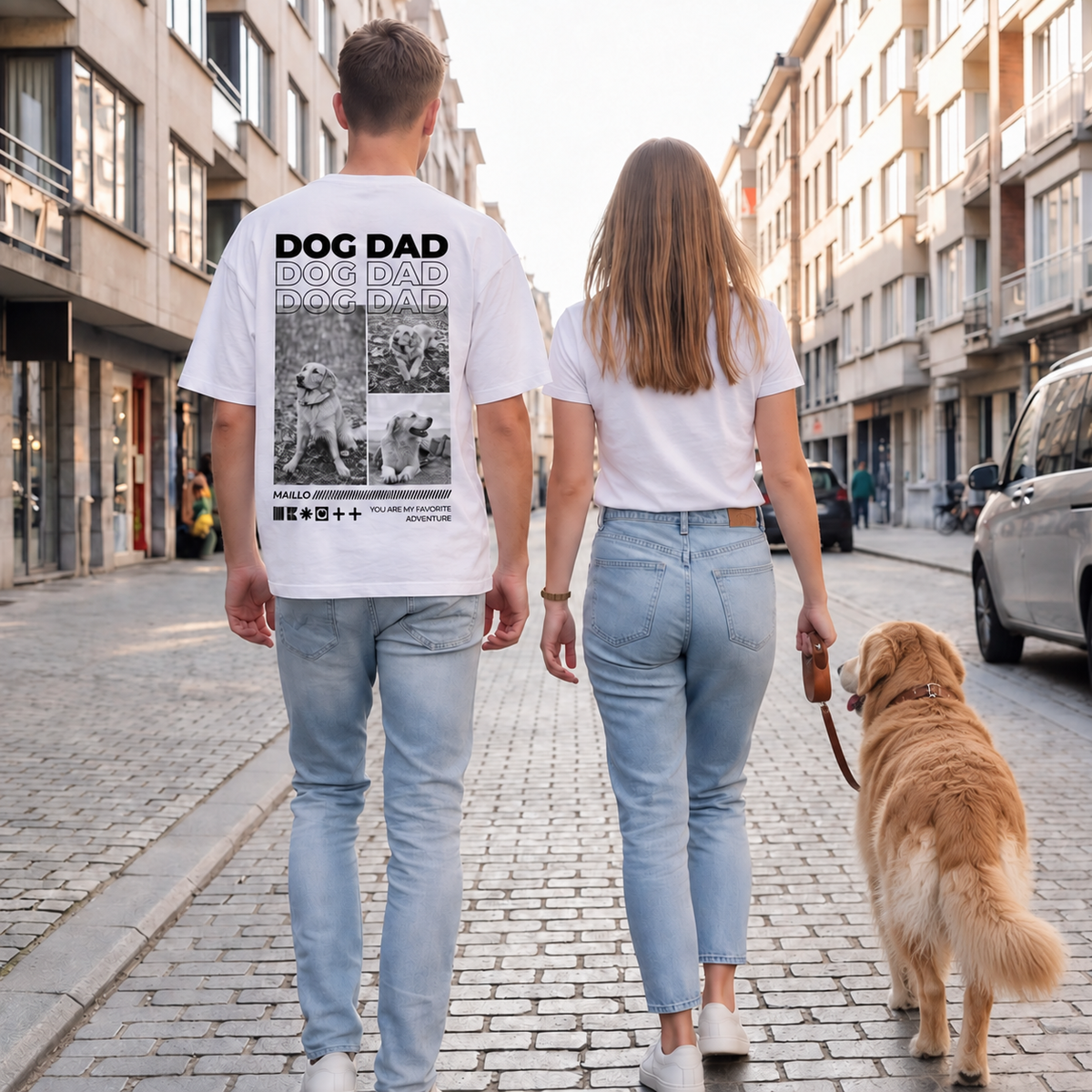Personas paseando un perro por la calle, una lleva una camiseta blanca con el motivo "DOG DAD".