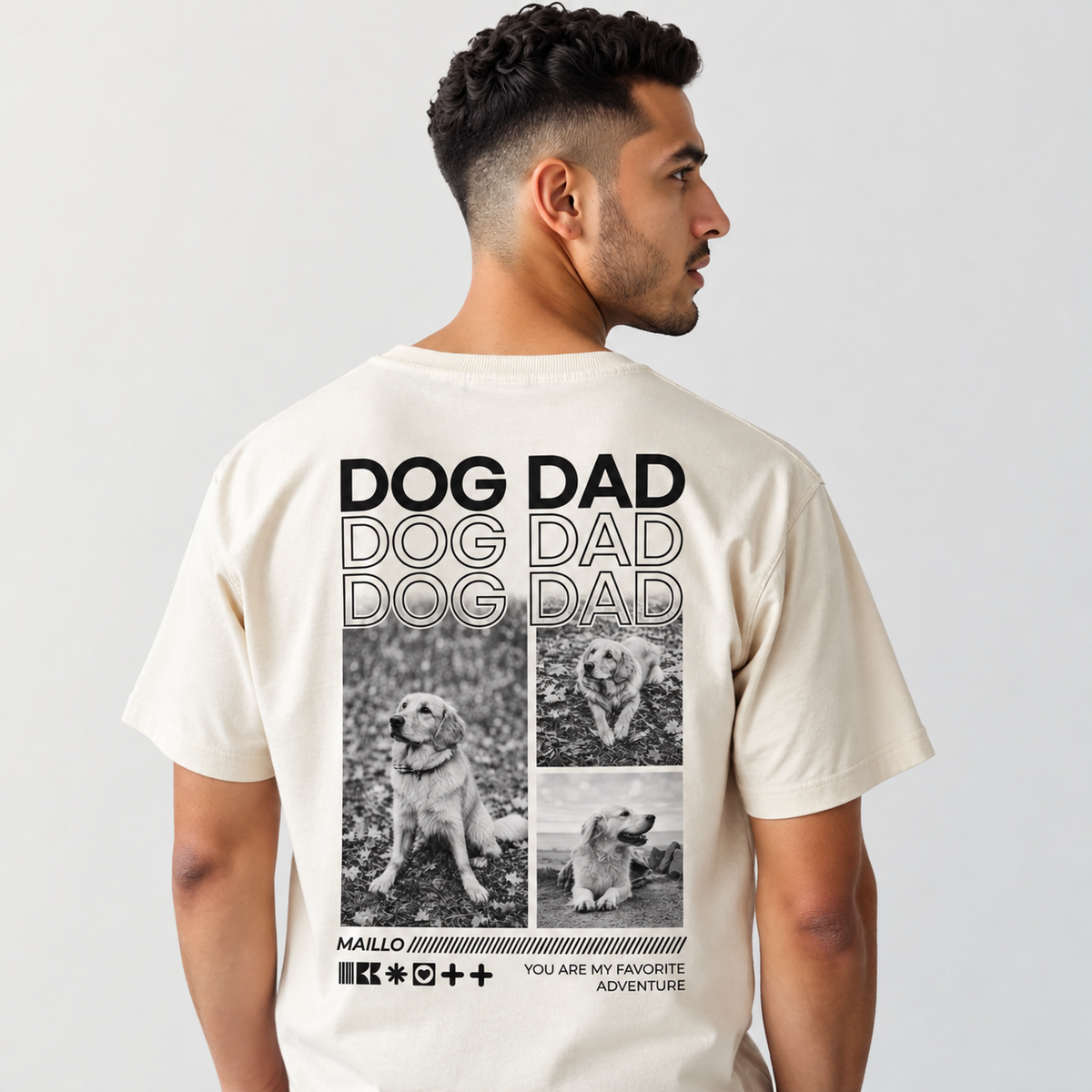 Camiseta beige con gráfico "DOG DAD" y fotos negras de perros en la espalda.