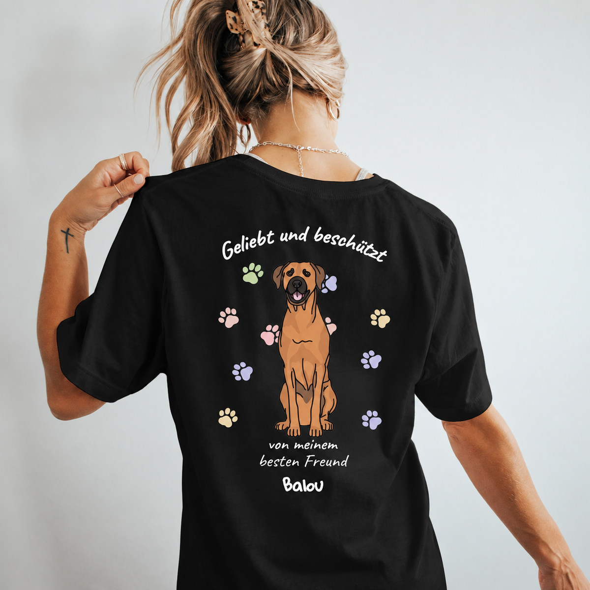 Camiseta negra con gráfico de perro y el texto "Geliebt und beschützt von meinem besten Freund Balou".