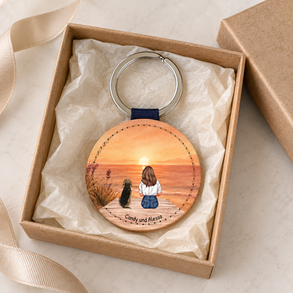Llavero de madera personalizado con un gráfico de una persona y un perro.
