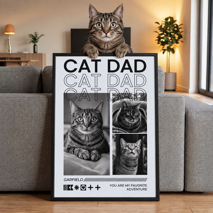 Gato sentado sobre un póster personalizado con el texto "CAT DAD" y fotos de distintos gatos.