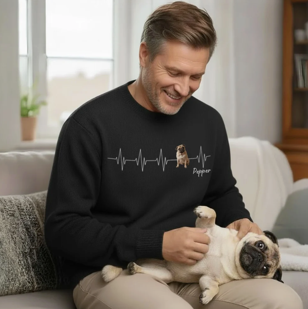 Sudadera negra con motivo de latido y perro, llevada por un hombre.