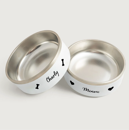 Comederos personalizados de acero inoxidable con exterior blanco, impresos con los nombres Charly y Minou.